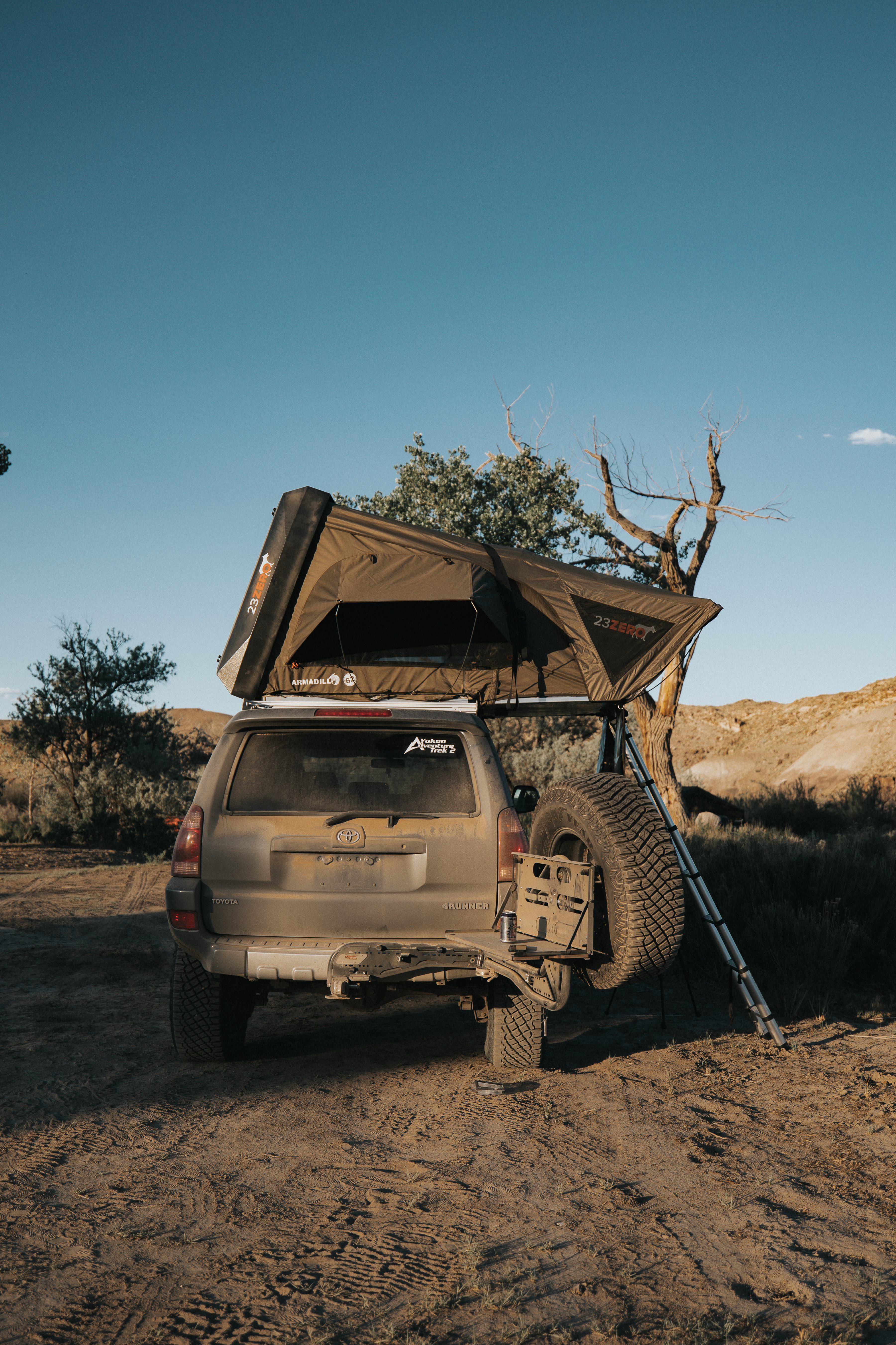 4Runner with Armadillo Hard Shell Rooftop Tent Deployed on Dusty Trail